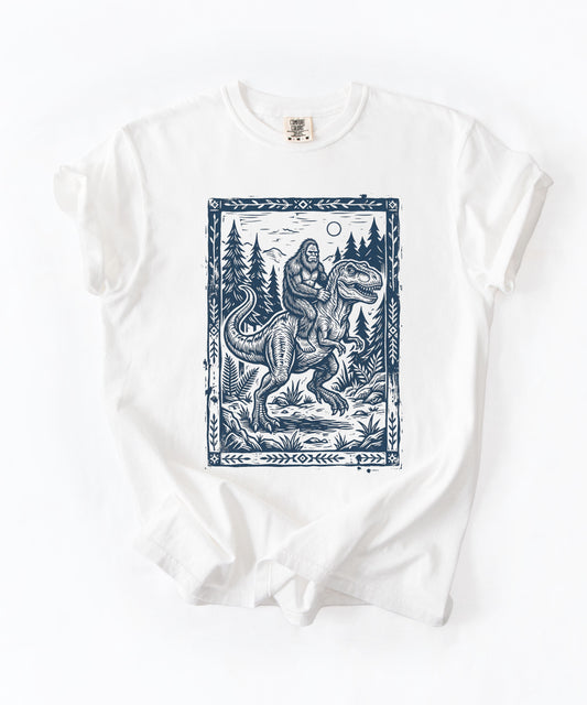 Bigfoot Riding T‑Rex T‑Shirt | Vintage Cryptid Dinosaur Graphic Tee | Wilderness Adventure Shirt